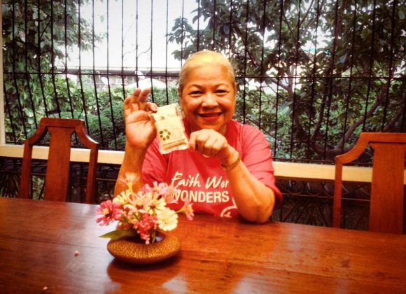 Vicky hand carries a $10 donation from a cabbie