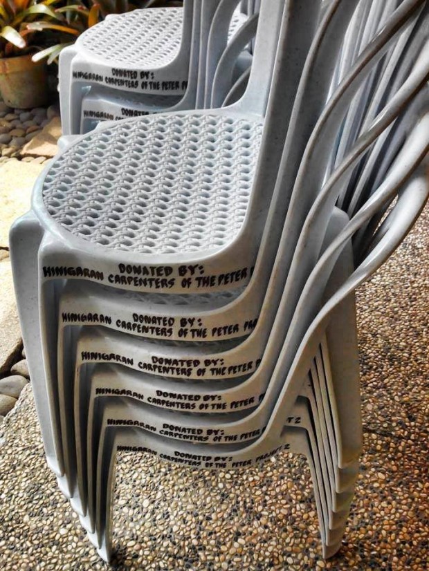 The beneficiaries of The Peter Project donate chairs to their church