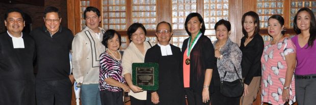 Millie Kilayko and the NVC team receiving the University of St. La Salle award