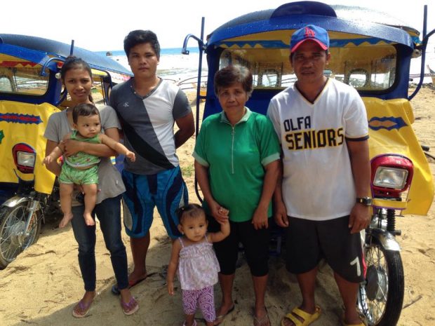 The Calvadores family, survivors of typhoon Haiyan, receives a tricycle from British American Tobacco
