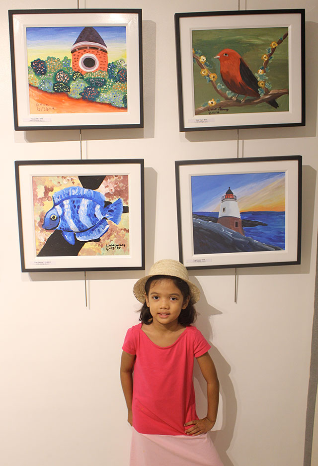 Lucia Galang with her paintings, now turned into Mingo eCards for charity