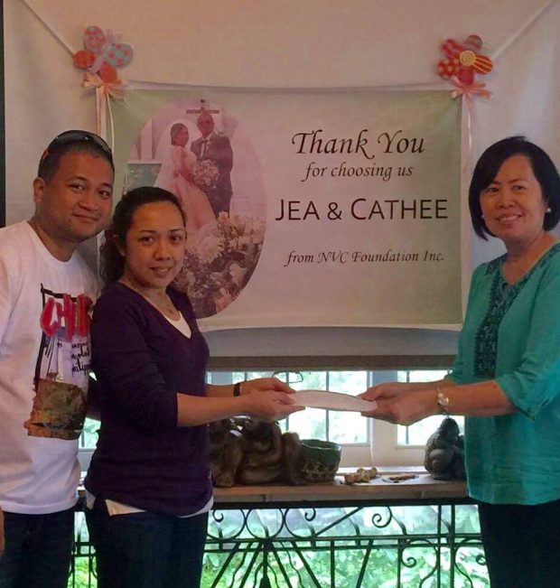 Cahtee and Jea turning over their "wedding gift" to NVC President Millie Kilayko
